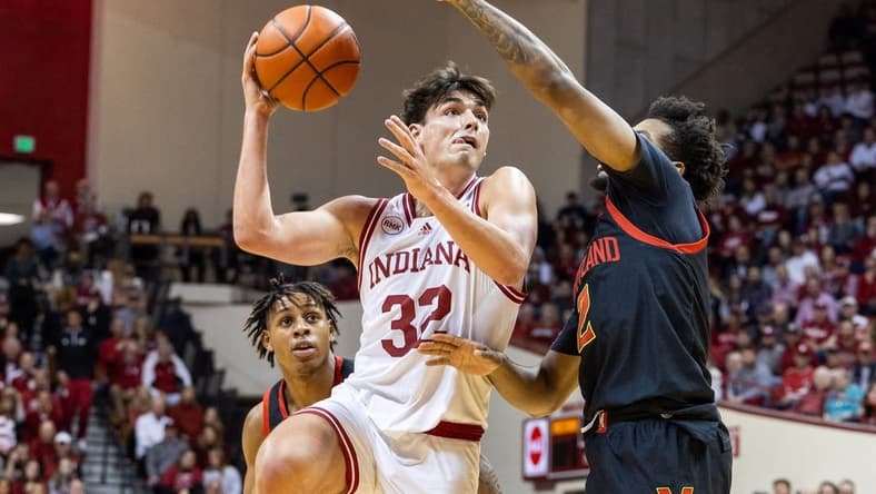 Dec 1, 2023; Bloomington, Indiana, USA; Indiana Hoosiers guard Trey Galloway (32) shoots the ball while Maryland Terrapins guard Jahari Long (2) defends in the first half at Simon Skjodt Assembly Hall. Mandatory Credit: Trevor Ruszkowski-USA TODAY Sports