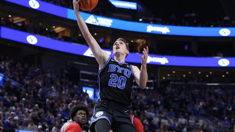 Dec 1, 2023; Salt Lake City, Utah, USA; Brigham Young Cougars guard Spencer Johnson (20) lays the ball up against the Fresno State Bulldogs during the first half at Delta Center. Mandatory Credit: Rob Gray-USA TODAY Sports