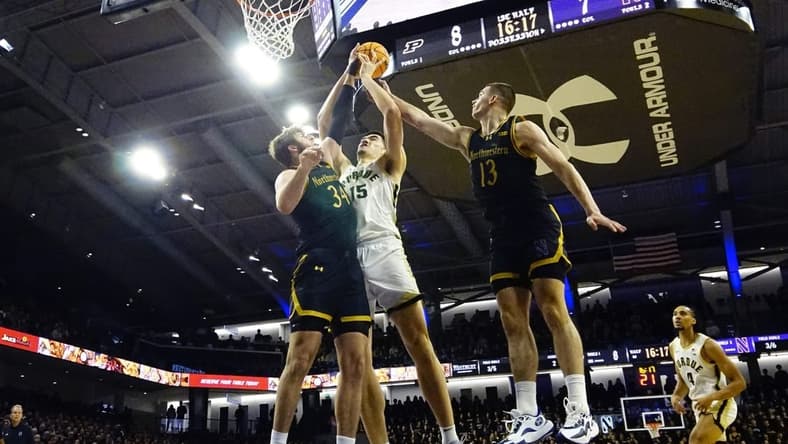 Dec 1, 2023; Evanston, Illinois, USA; Northwestern Wildcats center Matthew Nicholson (34) defends Purdue Boilermakers center Zach Edey (15) during the first half at Welsh-Ryan Arena. Mandatory Credit: David Banks-USA TODAY Sports
