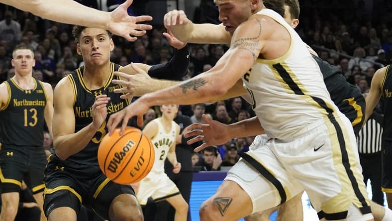 Dec 1, 2023; Evanston, Illinois, USA; Northwestern Wildcats guard Ty Berry (3) and Purdue Boilermakers forward Mason Gillis (0) go for a loose ball during the first half at Welsh-Ryan Arena. Mandatory Credit: David Banks-USA TODAY Sports