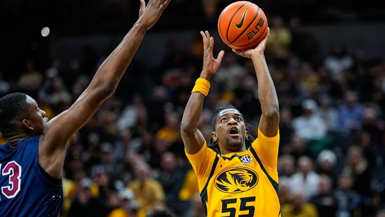 Nov 22, 2023; Columbia, Missouri, USA; Missouri Tigers guard Sean East II (55) shoots against South Carolina State Bulldogs center Drayton Jones (13) during the second half at Mizzou Arena. Mandatory Credit: Jay Biggerstaff-USA TODAY Sports
