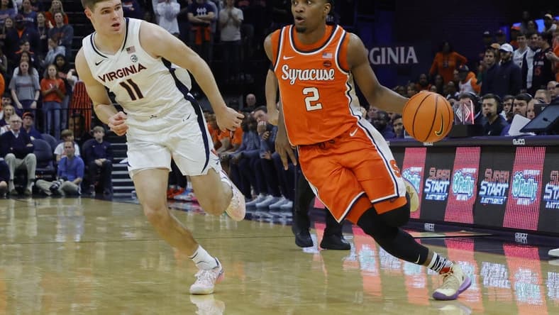 Dec 2, 2023; Charlottesville, Virginia, USA; Syracuse Orange guard JJ Starling (2) drives to the basket as Virginia Cavaliers guard Isaac McKneely (11) defends during the first half at John Paul Jones Arena. Mandatory Credit: Geoff Burke-USA TODAY Sports