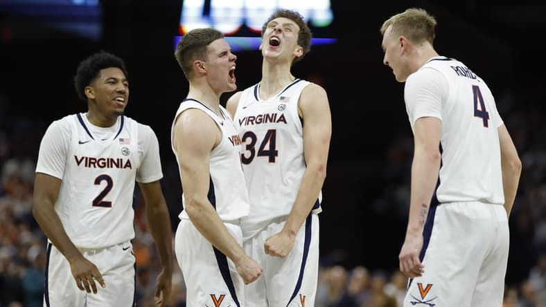 Dec 2, 2023; Charlottesville, Virginia, USA; Virginia Cavaliers guard Isaac McKneely (11) celebrates with teammates after a three point field goal against the Syracuse Orange during the first half at John Paul Jones Arena. Mandatory Credit: Geoff Burke-USA TODAY Sports