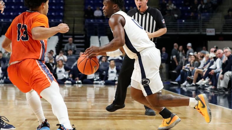 Dec 2, 2023; University Park, Pennsylvania, USA; Penn State Nittany Lions guard Kanye Clary (0) dribbles the ball against Bucknell Bison guard Josh Bascoe (13) during the first half at Bryce Jordan Center. Mandatory Credit: Matthew O'Haren-USA TODAY Sports