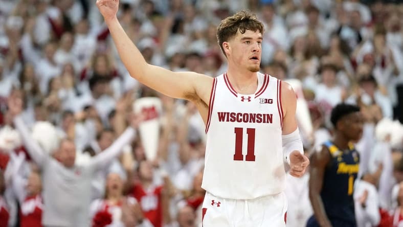 Dec 2, 2023; Madison, Wisconsin, USA; Wisconsin Badgers guard Max Klesmit (11) celebrates after scoring a three point basket against the Marquette Golden Eagles during the first half at the Kohl Center. Mandatory Credit: Kayla Wolf-USA TODAY Sports