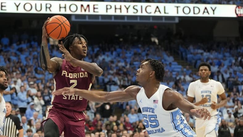 Dec 2, 2023; Chapel Hill, North Carolina, USA; Florida State Seminoles forward Jamir Watkins (2) with the ball as North Carolina Tar Heels forward Harrison Ingram (55) defends in the first half at Dean E. Smith Center. Mandatory Credit: Bob Donnan-USA TODAY Sports