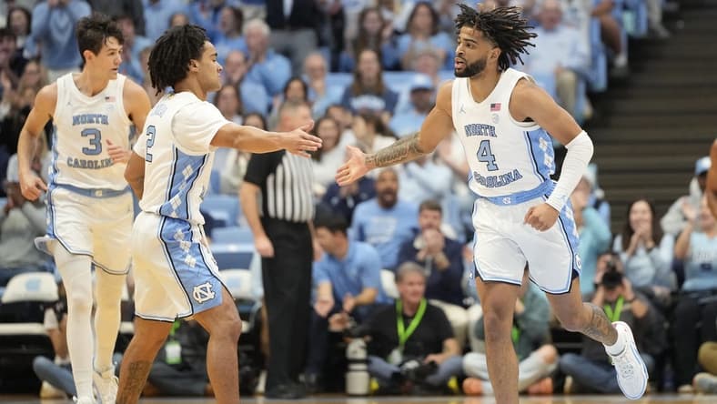 Dec 2, 2023; Chapel Hill, North Carolina, USA; North Carolina Tar Heels guard Elliot Cadeau (2) reacts with guard RJ Davis (4) in the first half at Dean E. Smith Center. Mandatory Credit: Bob Donnan-USA TODAY Sports