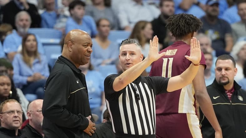 Dec 2, 2023; Chapel Hill, North Carolina, USA; Florida State Seminoles head coach Leonard Hamilton with the official in the first half at Dean E. Smith Center. Mandatory Credit: Bob Donnan-USA TODAY Sports