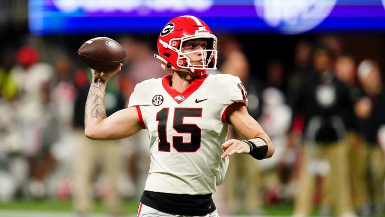 Dec 2, 2023; Atlanta, GA, USA; Georgia Bulldogs quarterback Carson Beck (15) throws a pass against the Alabama Crimson Tide in the third quarter of the SEC Championship at Mercedes-Benz Stadium. Mandatory Credit: John David Mercer-USA TODAY Sports