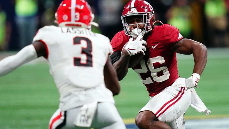 Dec 2, 2023; Atlanta, GA, USA; Alabama Crimson Tide running back Jam Miller (26) runs against Georgia Bulldogs defensive back Kamari Lassiter (3) in the fourth quarter of the SEC Championship at Mercedes-Benz Stadium. Mandatory Credit: John David Mercer-USA TODAY Sports