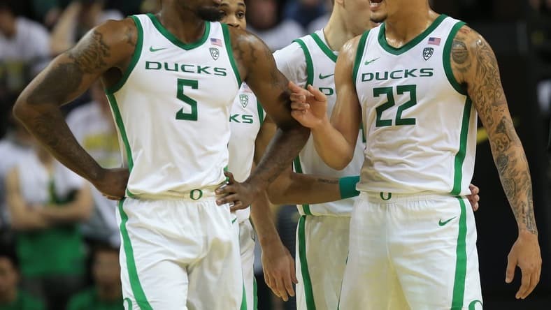 Oregon s Jermaine Couisnard, left, and Jadrian Tracey meet at mid court during their game against Michigan at Matthew Knight Arena in Eugene Saturday, Dec 2, 2023.