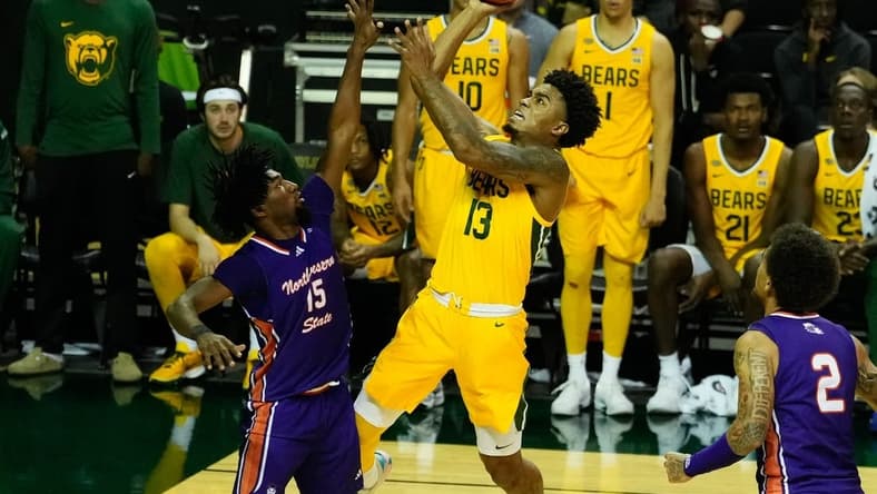 Dec 2, 2023; Waco, Texas, USA; Baylor Bears guard Langston Love (13) shoots against Northwestern State Demons guard Chase Forte (15) during the second half at Ferrell Center. Mandatory Credit: Chris Jones-USA TODAY Sports