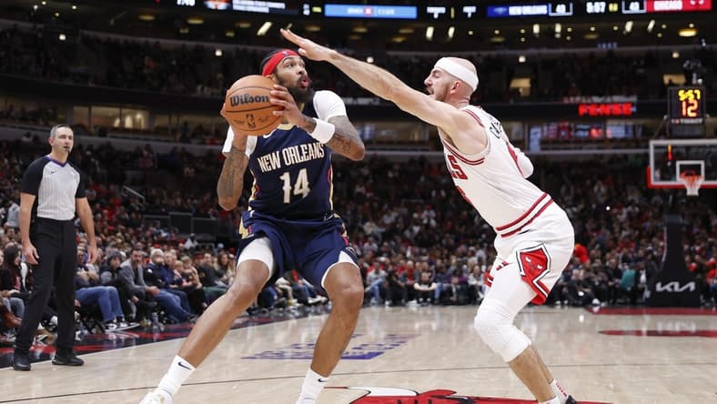Dec 2, 2023; Chicago, Illinois, USA; New Orleans Pelicans forward Brandon Ingram (14) looks to shoot against Chicago Bulls guard Alex Caruso (6) during the first half at United Center. Mandatory Credit: Kamil Krzaczynski-USA TODAY Sports