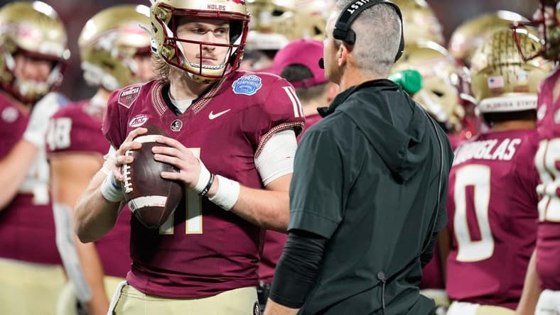 Dec 2, 2023; Charlotte, NC, USA; Florida State Seminoles quarterback Brock Glenn (11) speaks to head coach Mike Norvell on the sidelines during the third quarter against the Louisville Cardinals at Bank of America Stadium. Mandatory Credit: Jim Dedmon-USA TODAY Sports