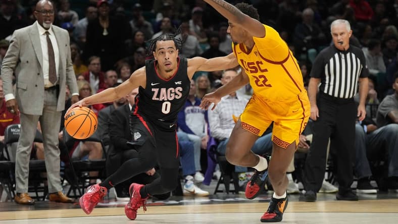 Dec 2, 2023; Las Vegas, Nevada, USA; Gonzaga Bulldogs guard Ryan Nembhard (0) dribbles against Southern California Trojans forward Arrinten Page (22) during the Legends of Basketball Las Vegas Invitational at MGM Grand Garden Arena. Mandatory Credit: Kirby Lee-USA TODAY Sports