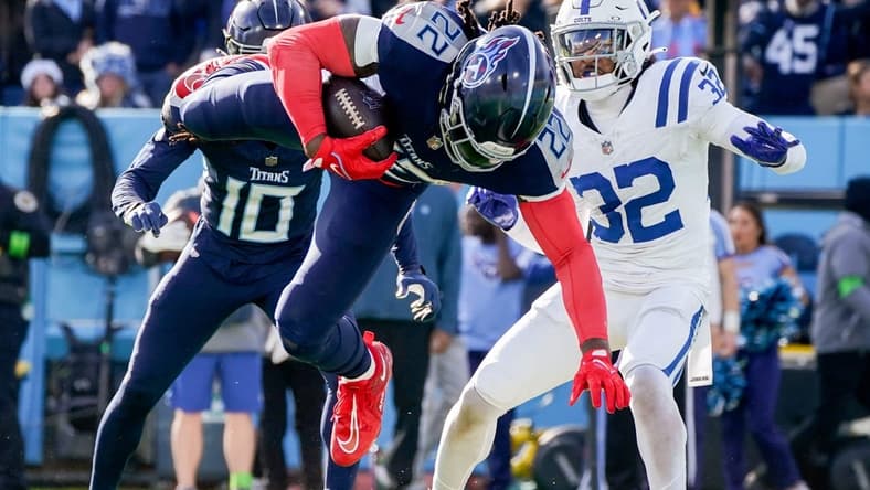 Tennessee Titans running back Derrick Henry (22) leaps for a touchdown against the Indianapolis Colts during the second quarter at Nissan Stadium in Nashville, Tenn., Sunday, Dec. 3, 2023.