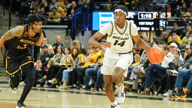 Dec 3, 2023; Columbia, Missouri, USA; Missouri Tigers guard Anthony Robinson II (14) steals the ball and dribbles as Wichita State Shockers guard Colby Rogers (4) defends during the first half at Mizzou Arena. Mandatory Credit: Denny Medley-USA TODAY Sports