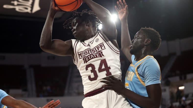 Dec 3, 2023; Starkville, Mississippi, USA; Mississippi State Bulldogs center Gai Chol (34) collects a rebound over Southern Jaguars forward Delang Muon (35) during the first half at Humphrey Coliseum. Mandatory Credit: Petre Thomas-USA TODAY Sports
