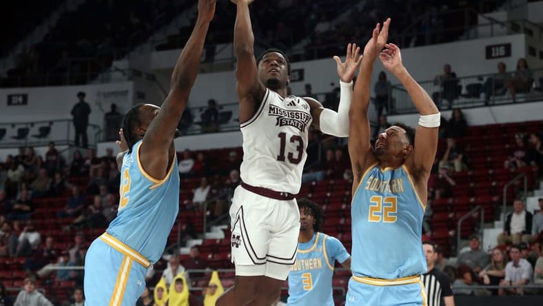 Dec 3, 2023; Starkville, Mississippi, USA; Mississippi State Bulldogs guard Josh Hubbard (13) shoots against Southern Jaguars forward Jalen Reynolds (12) and Southern Jaguars guard Tidjiane Dioumassi (22) during the first half at Humphrey Coliseum. Mandatory Credit: Petre Thomas-USA TODAY Sports