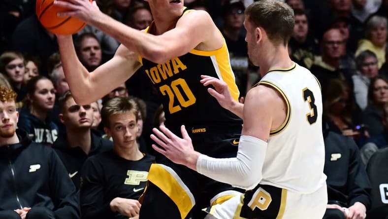 Dec 4, 2023; West Lafayette, Indiana, USA; Iowa Hawkeyes forward Payton Sandfort (20) looks to pass around Purdue Boilermakers guard Braden Smith (3) during the first half at Mackey Arena. Mandatory Credit: Marc Lebryk-USA TODAY Sports