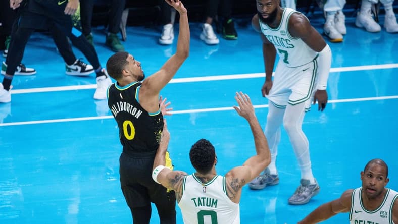 Dec 4, 2023; Indianapolis, Indiana, USA; Indiana Pacers guard Tyrese Haliburton (0) shoots while Boston Celtics forward Jayson Tatum (0)  defends in the first quarter at Gainbridge Fieldhouse. Mandatory Credit: Trevor Ruszkowski-USA TODAY Sports