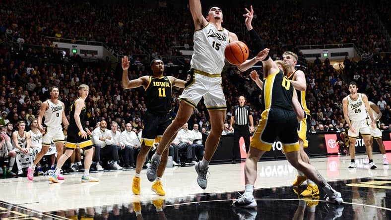 Dec 4, 2023; West Lafayette, Indiana, USA; Iowa Hawkeyes center Even Brauns (0) knocks the ball away from Purdue Boilermakers center Zach Edey (15) during the second half at Mackey Arena. Mandatory Credit: Marc Lebryk-USA TODAY Sports
