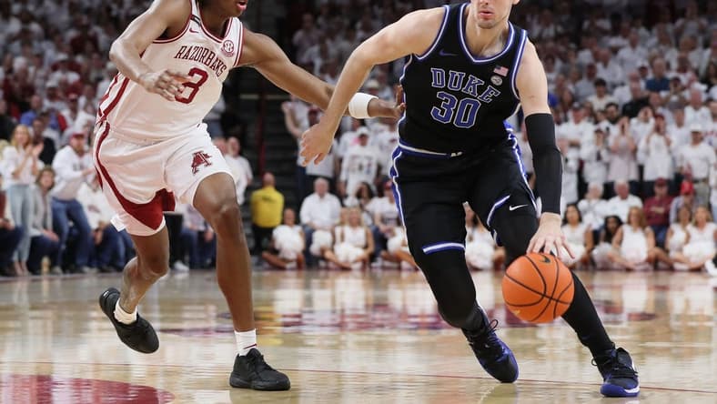 Nov 29, 2023; Fayetteville, Arkansas, USA; Duke Blue Devils center Kyle Filipowski (30) during the first half as Arkansas Razorbacks Chandler Lawson (8) defends at Bud Walton Arena. Arkansas won 80-75. Mandatory Credit: Nelson Chenault-USA TODAY Sports