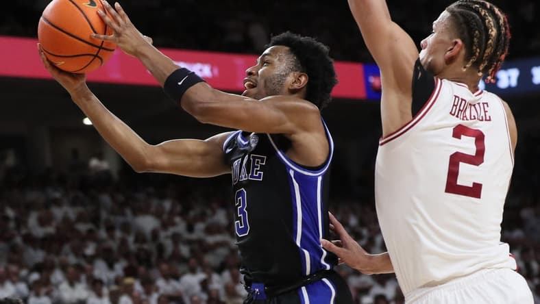 Nov 29, 2023; Fayetteville, Arkansas, USA; Duke Blue Devils guard Jeremy Roach (3) drives to the during the first half as Arkansas Razorbacks forward Trevon Brazile (2) defends at Bud Walton Arena. Arkansas won 80-75. Mandatory Credit: Nelson Chenault-USA TODAY Sports