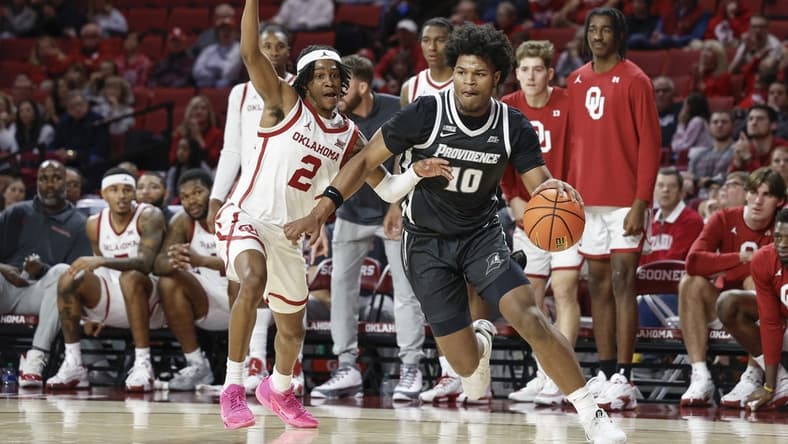 Dec 5, 2023; Norman, Oklahoma, USA; Providence Friars forward Rich Barron (10) drives against Oklahoma Sooners guard Javian McCollum (2) during the first half at Lloyd Noble Center. Mandatory Credit: Alonzo Adams-USA TODAY Sports