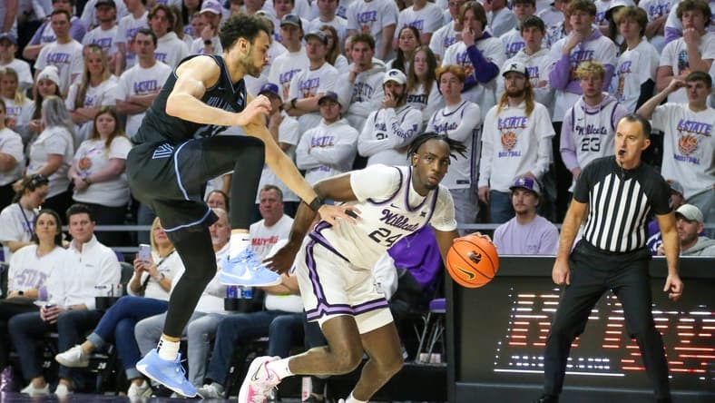 Dec 5, 2023; Manhattan, Kansas, USA; Kansas State Wildcats forward Arthur Maluma (24) dribbles by Villanova Wildcats forward Tyler Burton (23) during the first half at Bramlage Coliseum. Mandatory Credit: Scott Sewell-USA TODAY Sports