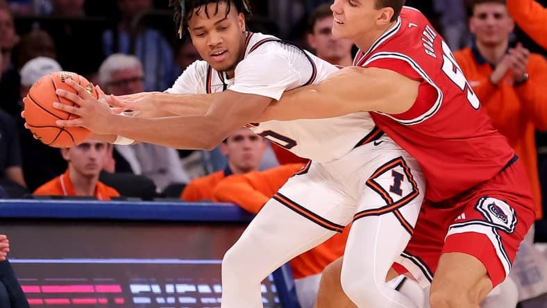 Dec 5, 2023; New York, New York, USA; Illinois Fighting Illini guard Terrence Shannon Jr. (0) is fouled by Florida Atlantic Owls center Vladislav Goldin (50) during the second half at Madison Square Garden. Mandatory Credit: Brad Penner-USA TODAY Sports