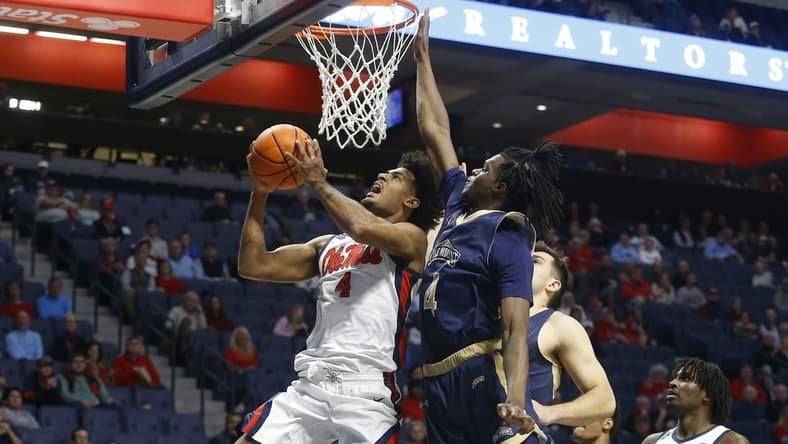 Dec 5, 2023; Oxford, Mississippi, USA; Mississippi Rebels forward Jaemyn Brakefield (4) drives to the basket as Mount St. Mary's Mountaineers forward Dola Adebayo (4) defends during the first half at The Sandy and John Black Pavilion at Ole Miss. Mandatory Credit: Petre Thomas-USA TODAY Sports
