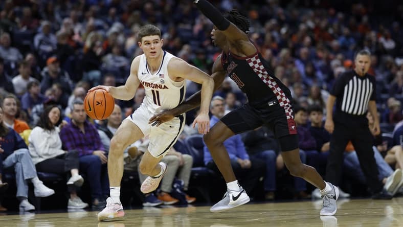 Dec 5, 2023; Charlottesville, Virginia, USA; Virginia Cavaliers guard Isaac McKneely (11) drives to the basket as North Carolina Central Eagles guard Keishon Porter (11) defends in the second half at John Paul Jones Arena. Mandatory Credit: Geoff Burke-USA TODAY Sports