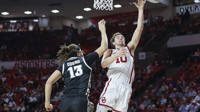 Dec 5, 2023; Norman, Oklahoma, USA; Oklahoma Sooners forward Sam Godwin (10) shoots as Providence Friars forward Josh Oduro (13) defends during the second half at Lloyd Noble Center. Mandatory Credit: Alonzo Adams-USA TODAY Sports