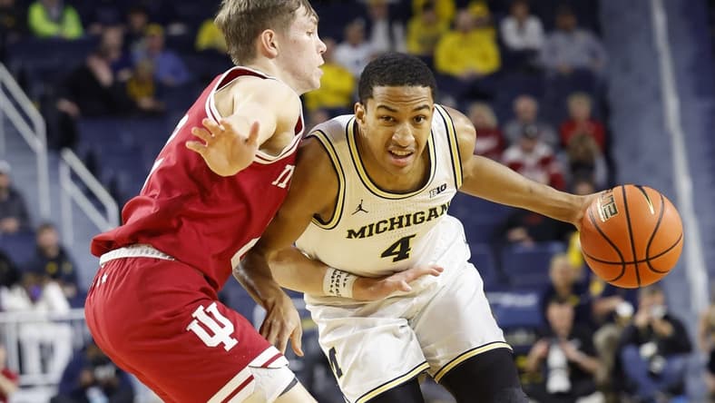 Dec 5, 2023; Ann Arbor, Michigan, USA; Michigan Wolverines guard Nimari Burnett (4) dribbles against Indiana Hoosiers guard Gabe Cupps (2) in the first half at Crisler Center. Mandatory Credit: Rick Osentoski-USA TODAY Sports