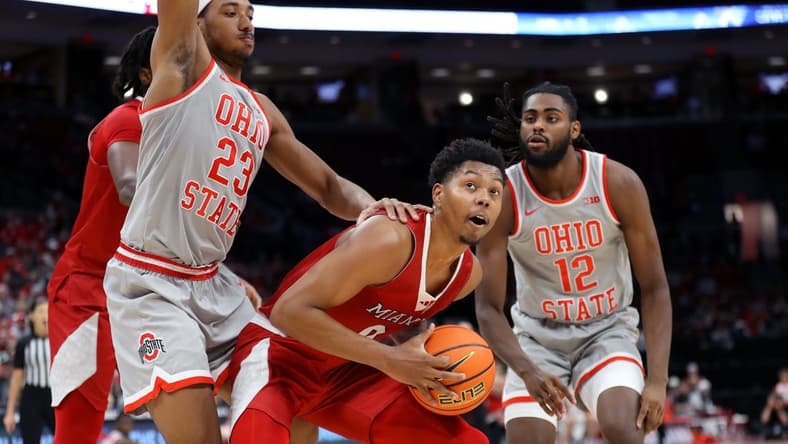 Dec 6, 2023; Columbus, Ohio, USA; Miami (Oh) Redhawks guard Eian Elmer (0) looks to score as Ohio State Buckeyes forward Zed Key (23) and guard Evan Mahaffey (12) defend during the first half at Value City Arena. Mandatory Credit: Joseph Maiorana-USA TODAY Sports
