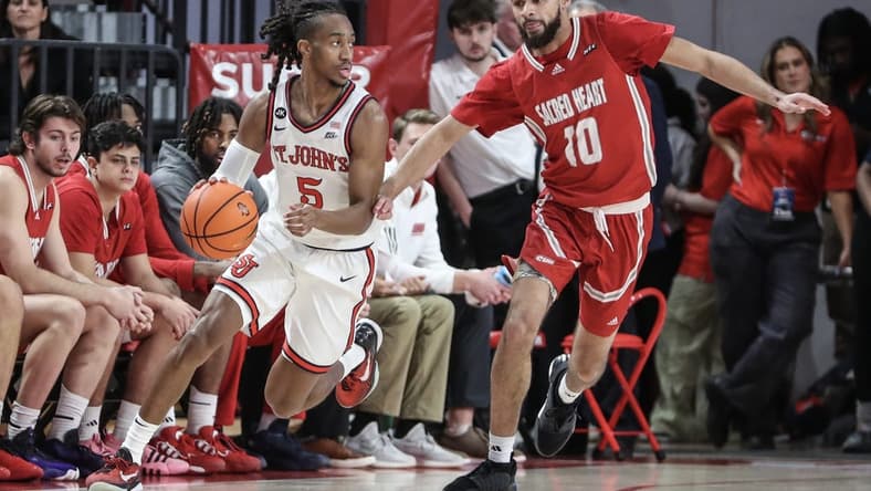 Dec 6, 2023; Queens, New York, USA; St. John's Red Storm guard Daniss Jenkins (5) drives past Sacred Heart Pioneers guard Kyle McGee (10) in the first half at Carnesecca Arena. Mandatory Credit: Wendell Cruz-USA TODAY Sports