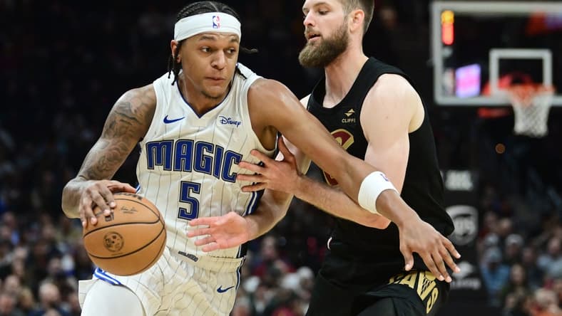 Dec 6, 2023; Cleveland, Ohio, USA; Orlando Magic forward Paolo Banchero (5) drives to the basket against Cleveland Cavaliers forward Dean Wade (32) during the first half at Rocket Mortgage FieldHouse. Mandatory Credit: Ken Blaze-USA TODAY Sports