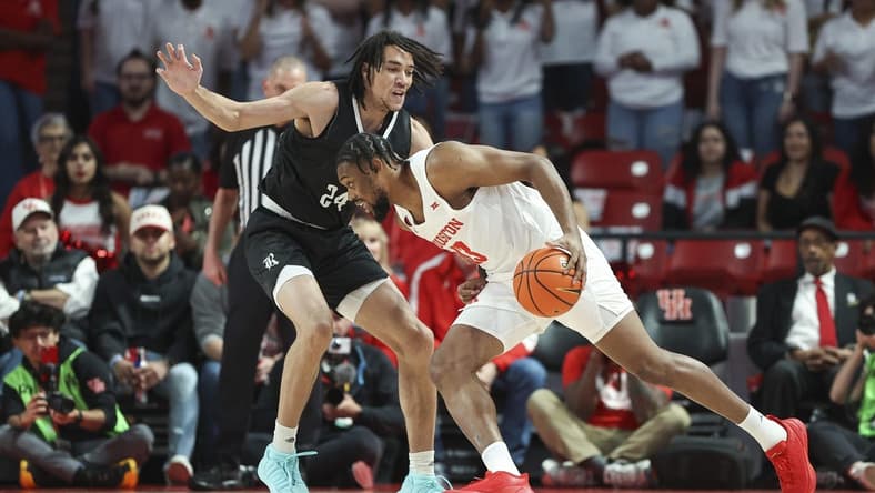 Dec 6, 2023; Houston, Texas, USA; Houston Cougars forward J'Wan Roberts (13) drives with the ball as Rice Owls forward Keanu Dawes (24) defends during the first half at Fertitta Center. Mandatory Credit: Troy Taormina-USA TODAY Sports