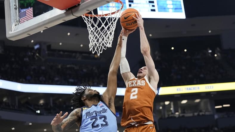 Dec 6, 2023; Milwaukee, Wisconsin, USA;  Texas Longhorns guard Chendall Weaver (2) shoots over Marquette Golden Eagles forward David Joplin (23) during the first half at Fiserv Forum. Mandatory Credit: Jeff Hanisch-USA TODAY Sports
