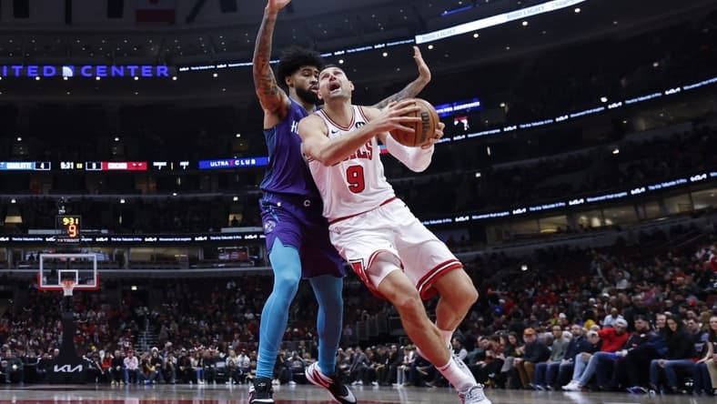 Dec 6, 2023; Chicago, Illinois, USA; Chicago Bulls center Nikola Vucevic (9) drives to the basket against Charlotte Hornets center Nick Richards (4) during the first half at United Center. Mandatory Credit: Kamil Krzaczynski-USA TODAY Sports
