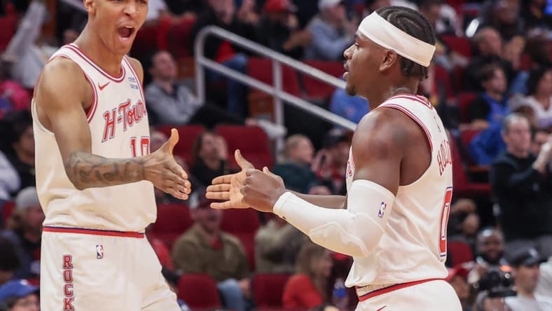 Dec 6, 2023; Houston, Texas, USA;  Houston Rockets forward Jabari Smith Jr. (10) reacts a basket by guard Aaron Holiday (0) against the Oklahoma City Thunder in the second half at Toyota Center. Mandatory Credit: Thomas Shea-USA TODAY Sports