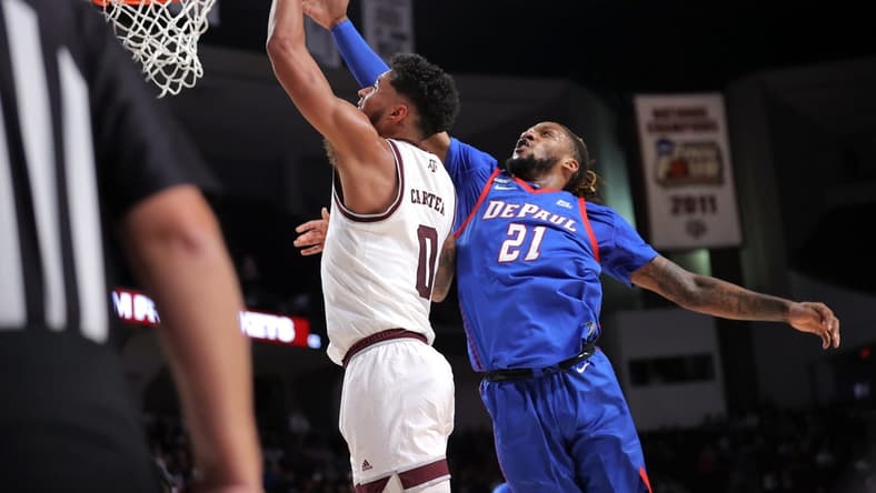 Dec 6, 2023; College Station, Texas, USA; Texas A&M Aggies guard Jace Carter (0) shoots an inside shot against DePaul Blue Demons forward Da'Sean Nelson (21) during the first half at Reed Arena. Mandatory Credit: Erik Williams-USA TODAY Sports