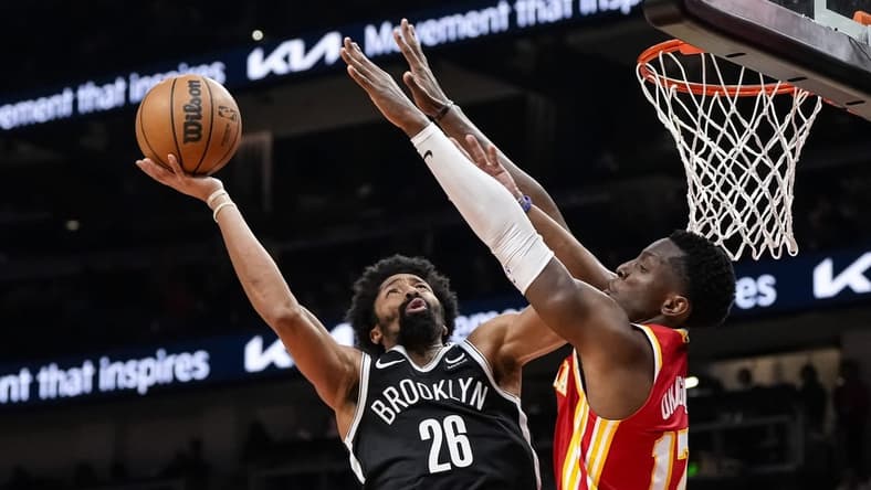 Dec 6, 2023; Atlanta, Georgia, USA; Brooklyn Nets guard Spencer Dinwiddie (26) shoots defended by Atlanta Hawks forward Onyeka Okongwu (17) during the second half at State Farm Arena. Mandatory Credit: Dale Zanine-USA TODAY Sports