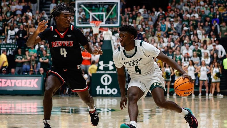 Dec 6, 2023; Fort Collins, Colorado, USA; Colorado State Rams guard Isaiah Stevens (4) controls the ball as Denver Pioneers guard DeAndre Craig (4) guards in the second half at Moby Arena. Mandatory Credit: Isaiah J. Downing-USA TODAY Sports