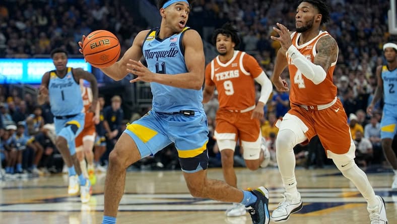 Dec 6, 2023; Milwaukee, Wisconsin, USA; Marquette guard Stevie Mitchell (4) gets past Texas guard Tyrese Hunter (4) on a fast break during the first half of their game at Fiserv Forum. Mandatory Credit: Jeff Hanisch-USA TODAY Sports