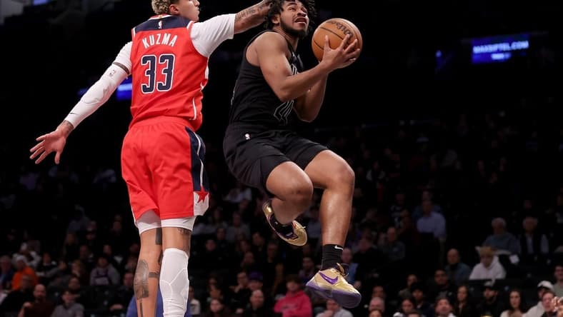 Dec 8, 2023; Brooklyn, New York, USA; Brooklyn Nets guard Cam Thomas (24) drives to the basket against Washington Wizards forward Kyle Kuzma (33) during the first quarter at Barclays Center. Mandatory Credit: Brad Penner-USA TODAY Sports