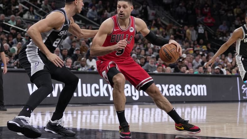 Dec 8, 2023; San Antonio, Texas, USA;  Chicago Bulls center Nikola Vucevic (9) moves against San Antonio Spurs forward Zach Collins (23) in the first half at the Frost Bank Center. Mandatory Credit: Daniel Dunn-USA TODAY Sports