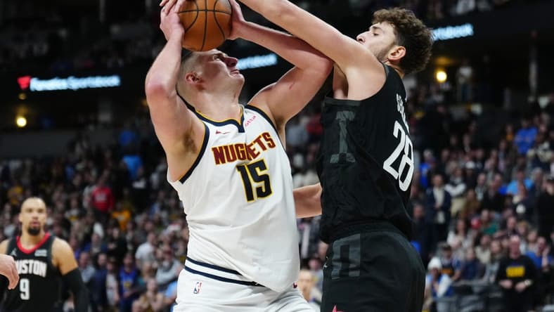 Dec 8, 2023; Denver, Colorado, USA; Houston Rockets center Alperen Sengun (28) blocks a shot by Denver Nuggets center Nikola Jokic (15) in the second half at Ball Arena. Mandatory Credit: Ron Chenoy-USA TODAY Sports