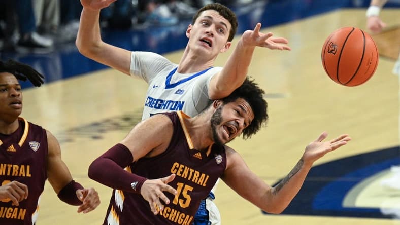 Dec 9, 2023; Omaha, Nebraska, USA; Creighton Bluejays center Ryan Kalkbrenner (11) fouls Central Michigan Chippewas forward Markus Harding (15) on a rebound attempt in the first half at CHI Health Center Omaha. Mandatory Credit: Steven Branscombe-USA TODAY Sports